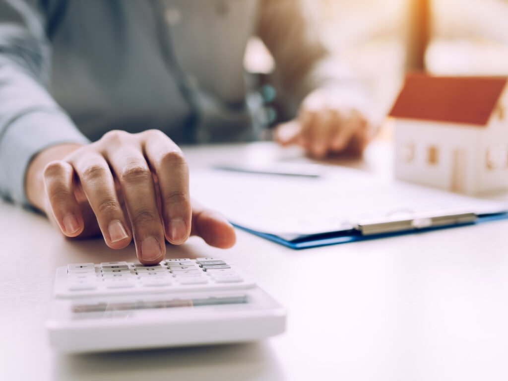 Close up of someone using a calculator to calculate the mortgage payments.