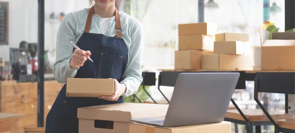 Person taking stock of inventory while looking at a laptop