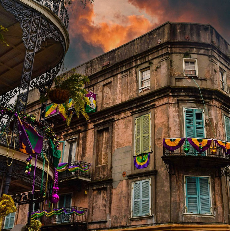 Historic New Orleans building on the corner of Royal Street and St. Peter in disrepair and decked out for Mardi Gras