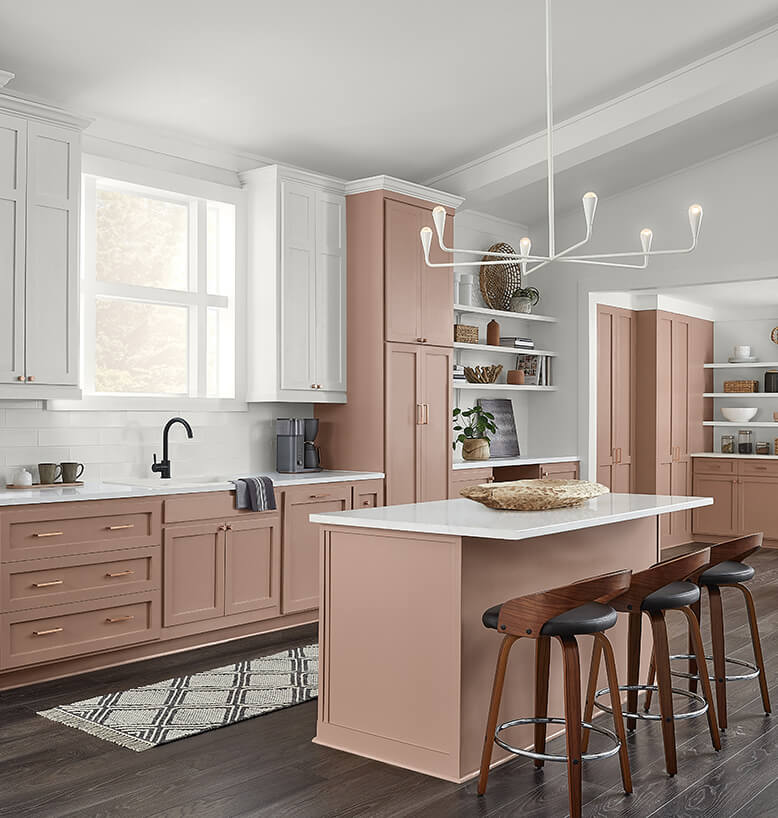 A modern kitchen with cabinets painted in the Sherwin Williams 2023 color of the year, Redend Point