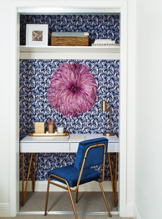 Desk and chair within a closet.