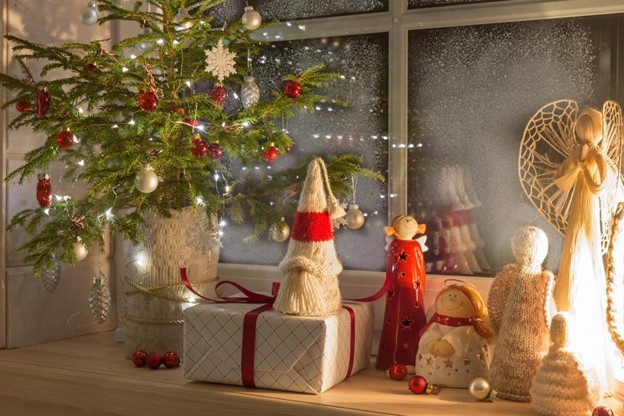 holiday decorations sitting in front of a frosty window
