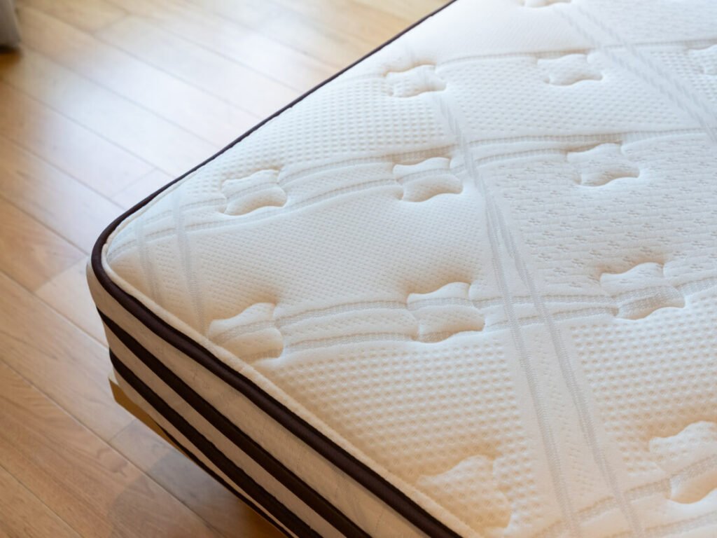 Cropped image of a bare mattress on the floor