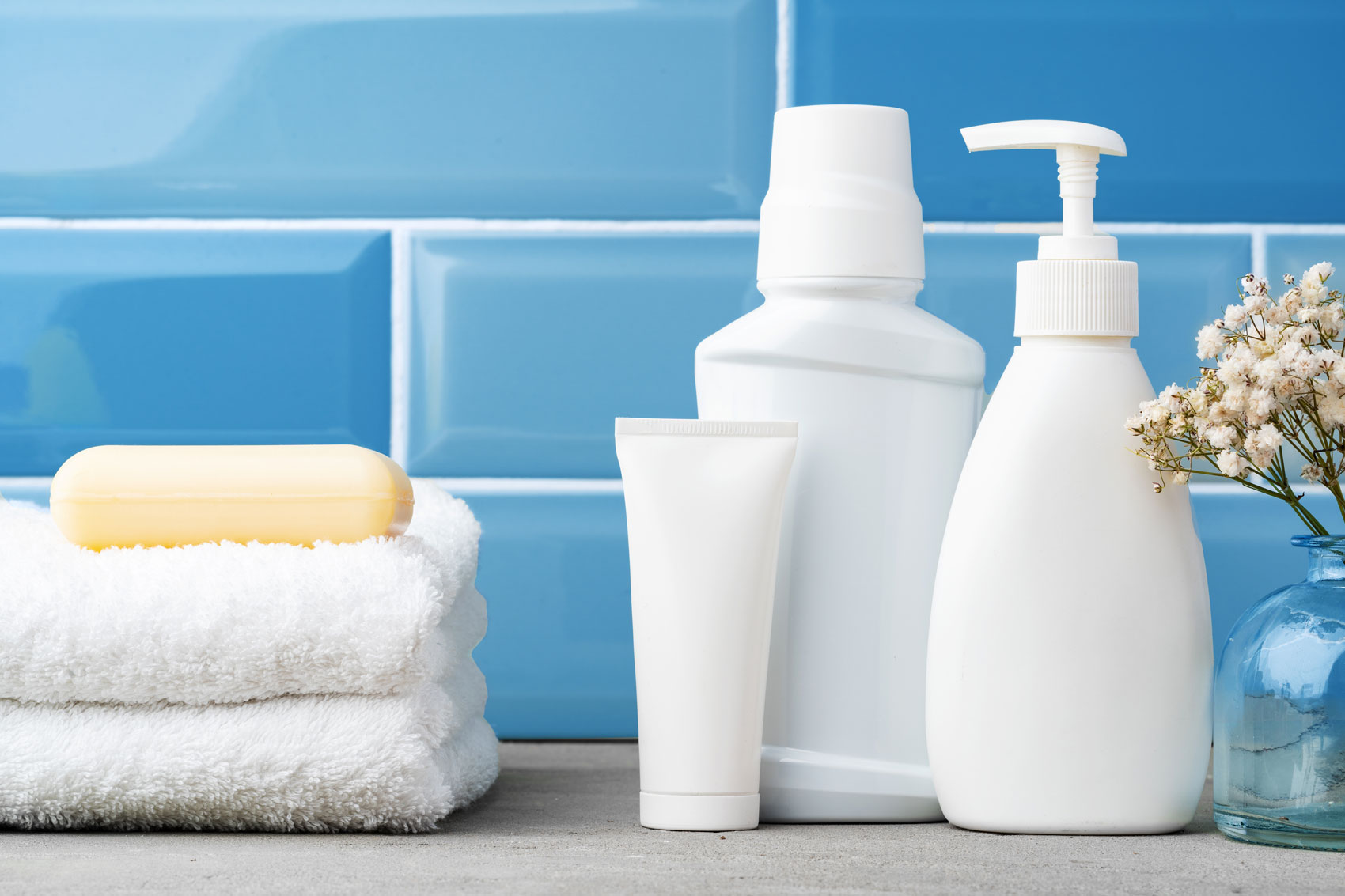 Soap and toiletries on shelf in blue bathroom
