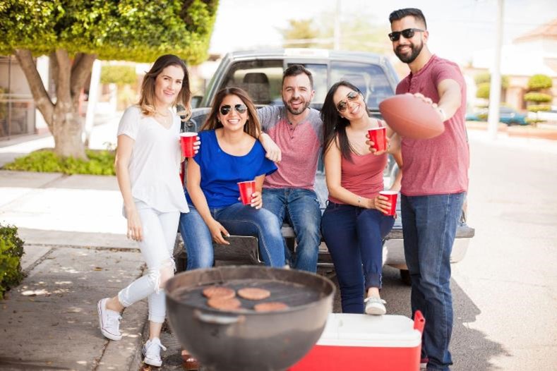 Friends around a tailgating vehicle